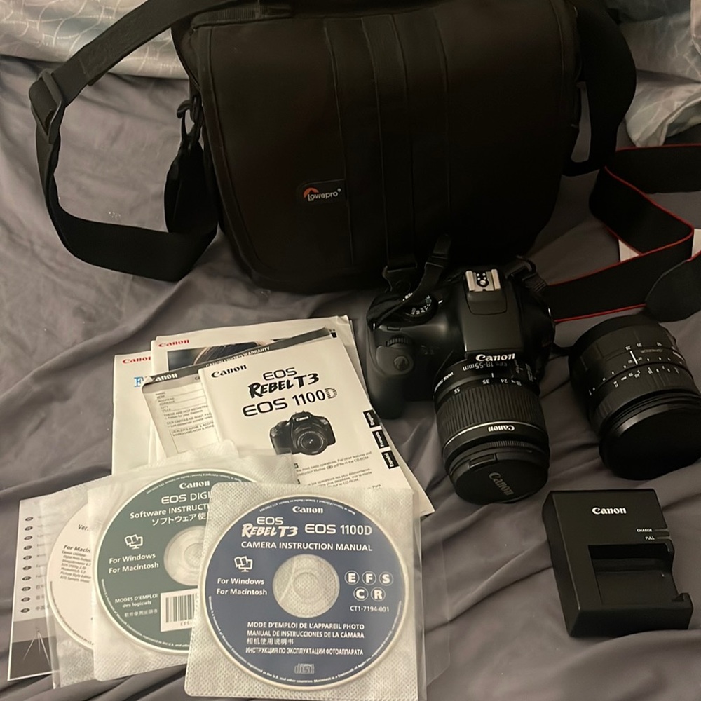 TOTAL CAMERA PACKAGE INCLUDES CANON T3 REBEL CAMERA, TELEPHOTO LENSE AND BAG